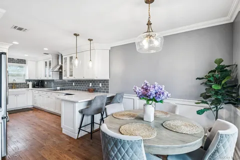 a kitchen with a refrigerator and a white sink