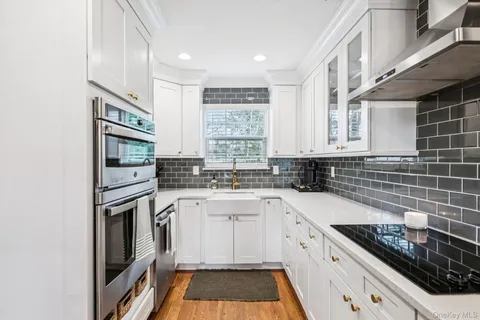 a kitchen with a sink stove and cabinets