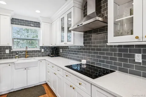 a kitchen with a sink stove and cabinets