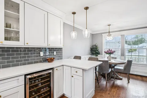 a view of a kitchen area with furniture and wooden floor