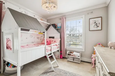 a bedroom with baby toys and a window