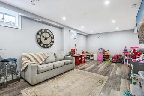 a bedroom with furniture and a flat screen tv
