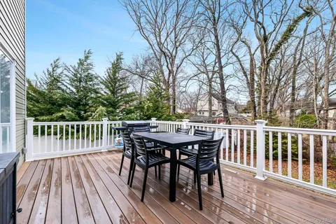 a view of backyard with a deck and wooden floor
