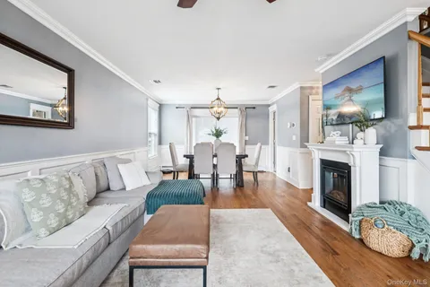 a living room with fireplace furniture and a fireplace