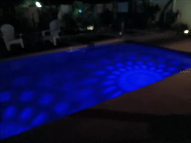 a walk in closet with wooden floor