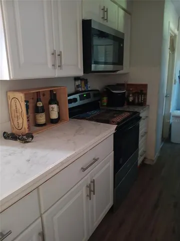 a view of a chair and table and garden in the back
