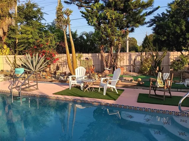 a view of a backyard with sitting area
