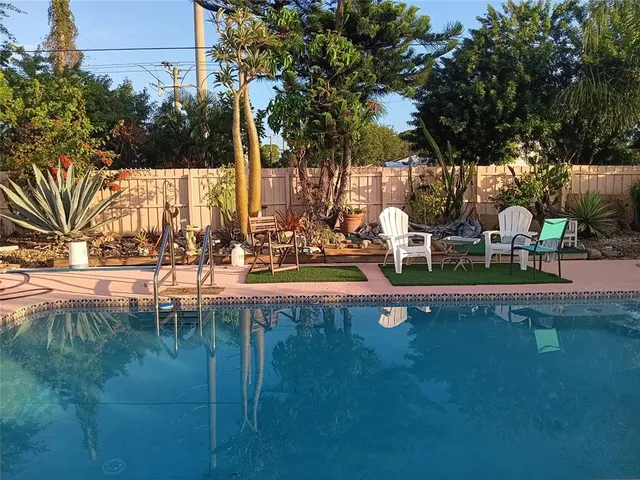 a view of a house with backyard porch and sitting area
