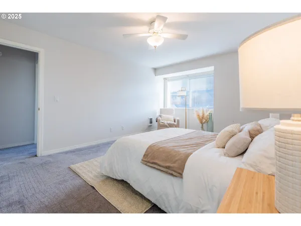 a bedroom with a bed and a ceiling fan