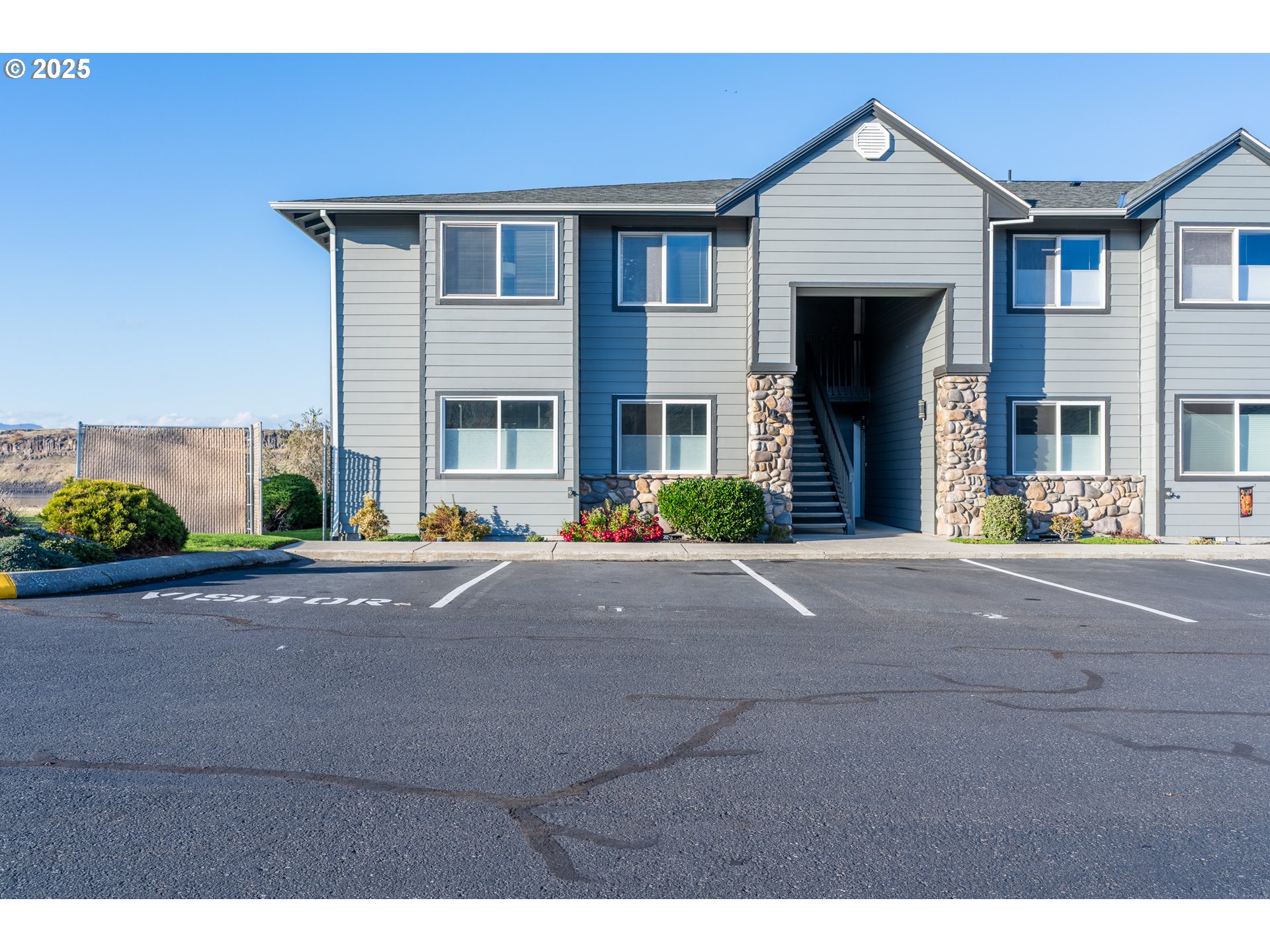 240 Lone Pine Lane, Unit 2 The Dalles, OR 97058 - Photo 3 of 37 a front view of a house with a yard and garage