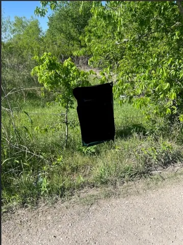 a view of a yard with iron fence