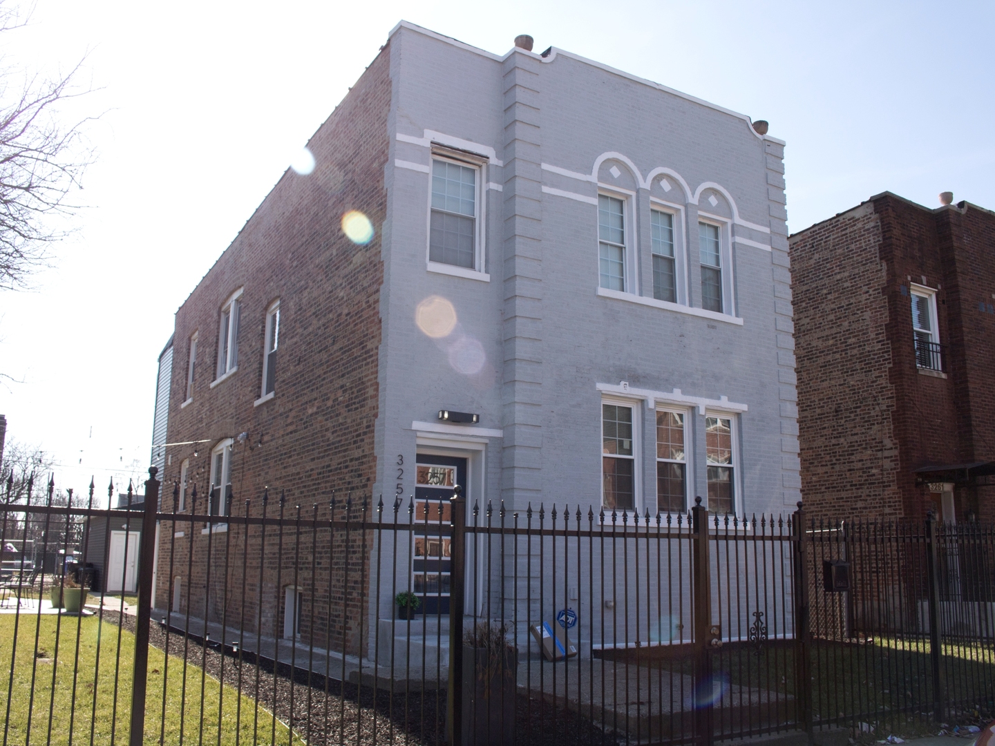 3257 West Warren Boulevard, Unit 2 Chicago, IL 60624 - Photo 1 of 10 a view of a brick building next to a yard