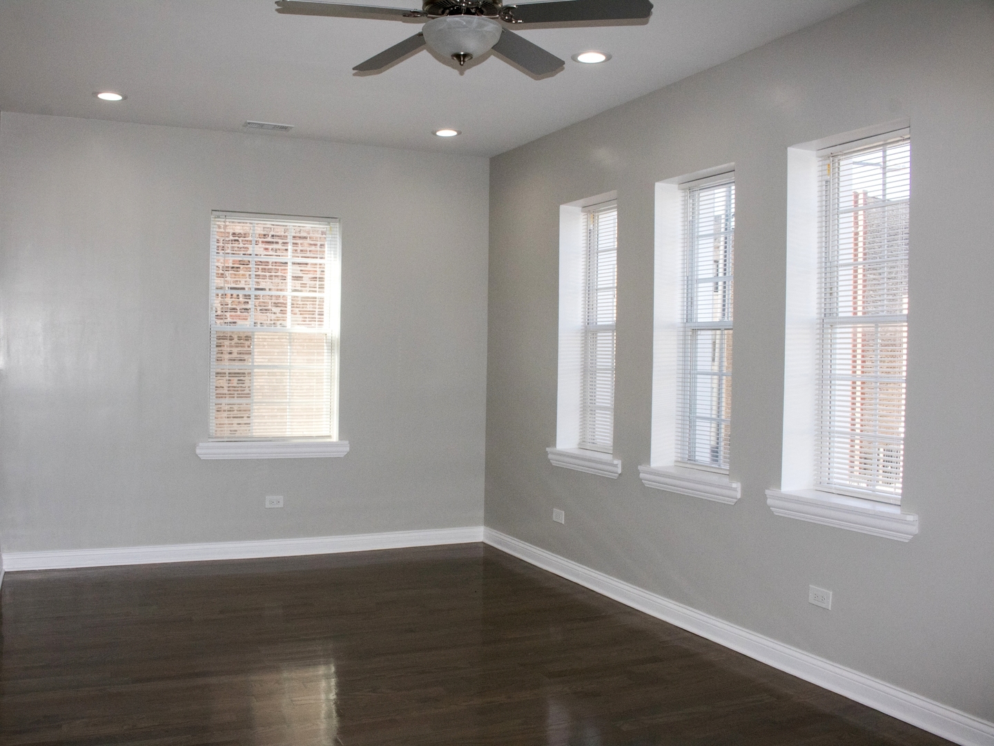 3257 West Warren Boulevard, Unit 2 Chicago, IL 60624 - Photo 2 of 10 a view of an empty room with wooden floor and a window