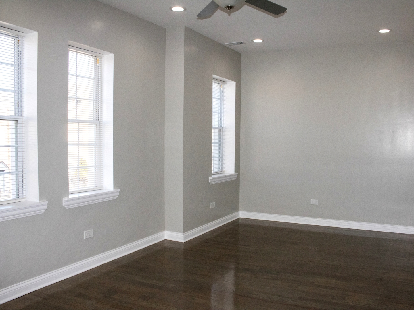 3257 West Warren Boulevard, Unit 2 Chicago, IL 60624 - Photo 3 of 10 an empty room with wooden floor and windows
