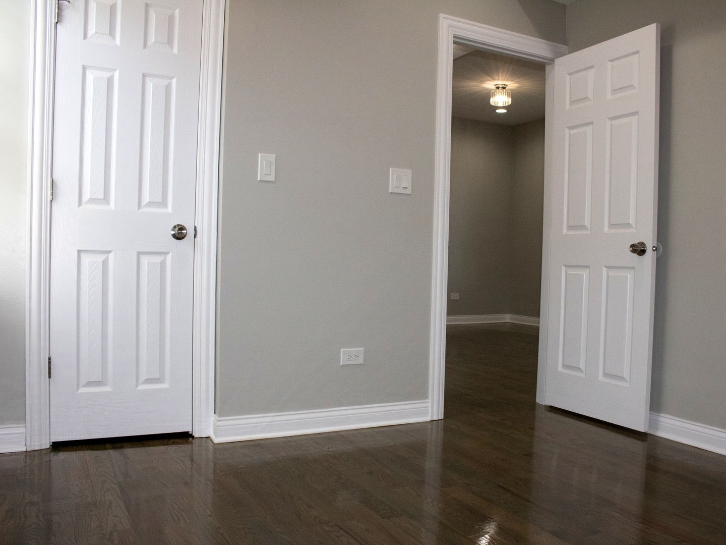 3257 West Warren Boulevard, Unit 2 Chicago, IL 60624 - Photo 6 of 10 an empty room with wooden floor and windows