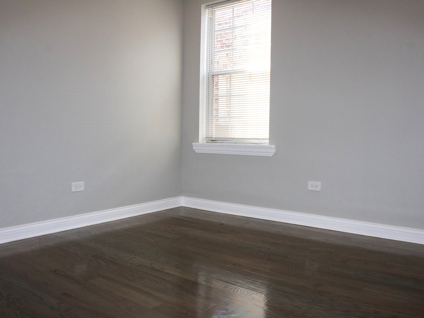 3257 West Warren Boulevard, Unit 2 Chicago, IL 60624 - Photo 7 of 10 an empty room with wooden floor and windows