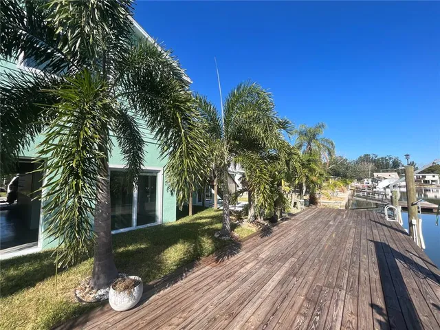 a view of a balcony with chairs and wooden floor