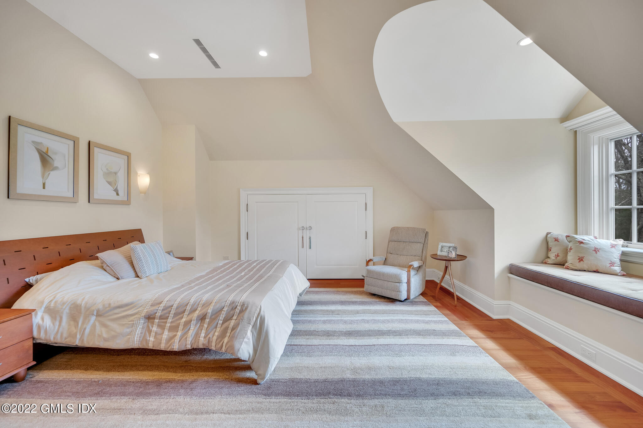 19 French Road Greenwich, CT 06831 - Photo 24 of 32 a bedroom with a large bed and wooden floor