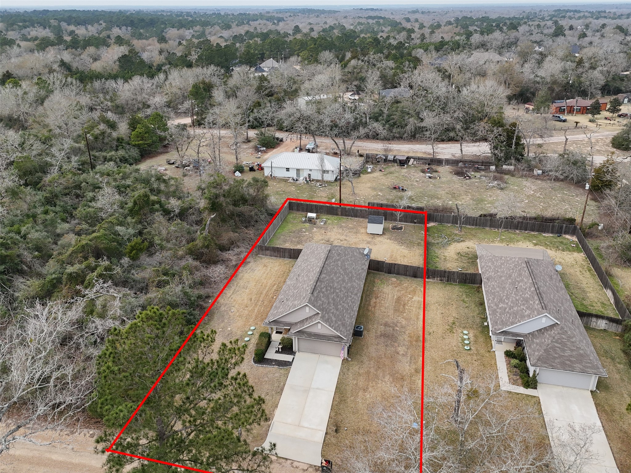 26431 Pin Oak Drive Hempstead, TX 77445 - Photo 5 of 32 Aerial view highlighting the home’s lot placement with clear boundary outline and surrounding neighborhood context. Wooded area along the side adds a natural buffer and added privacy.