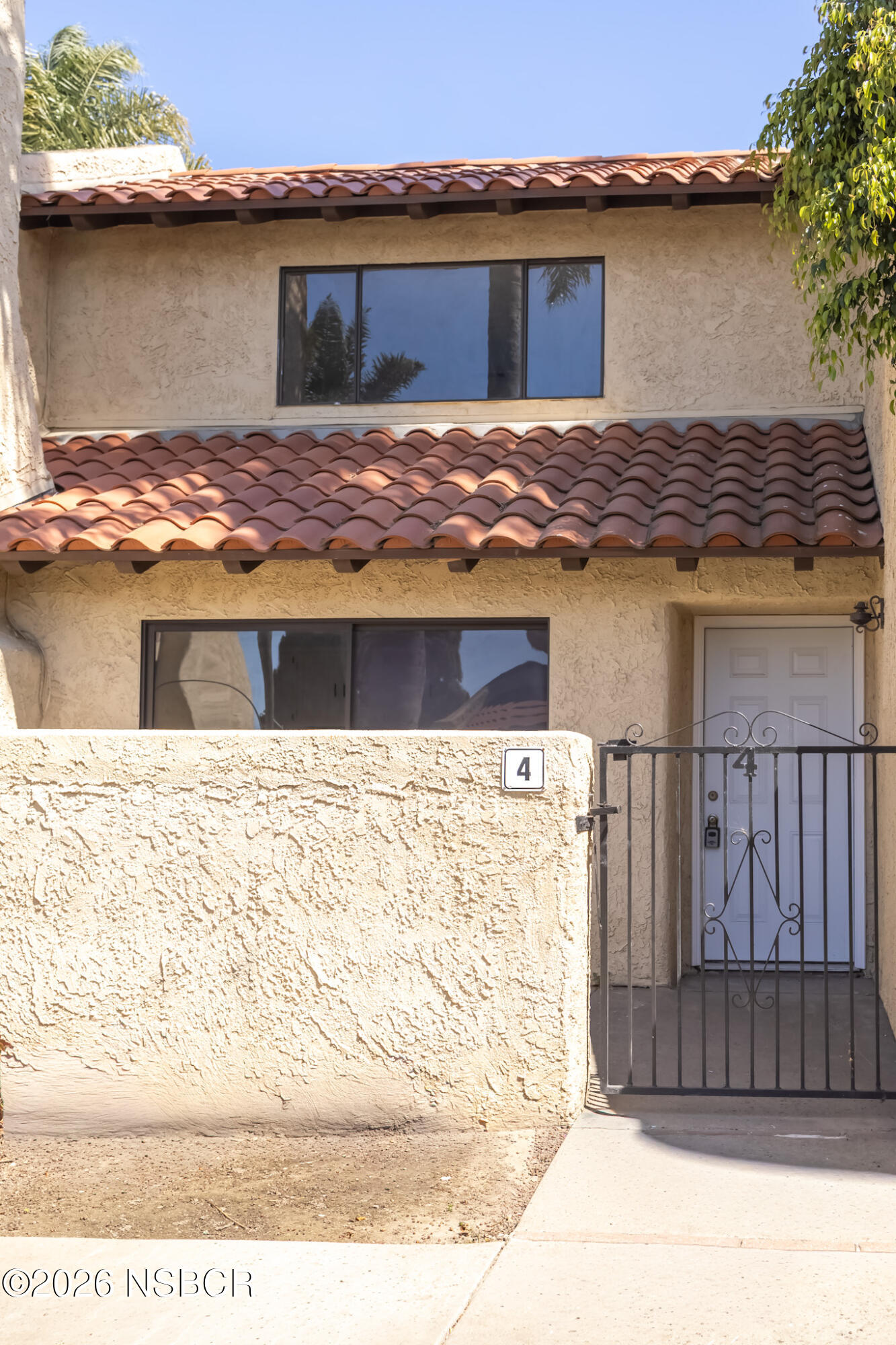 a view of house with wooden fence