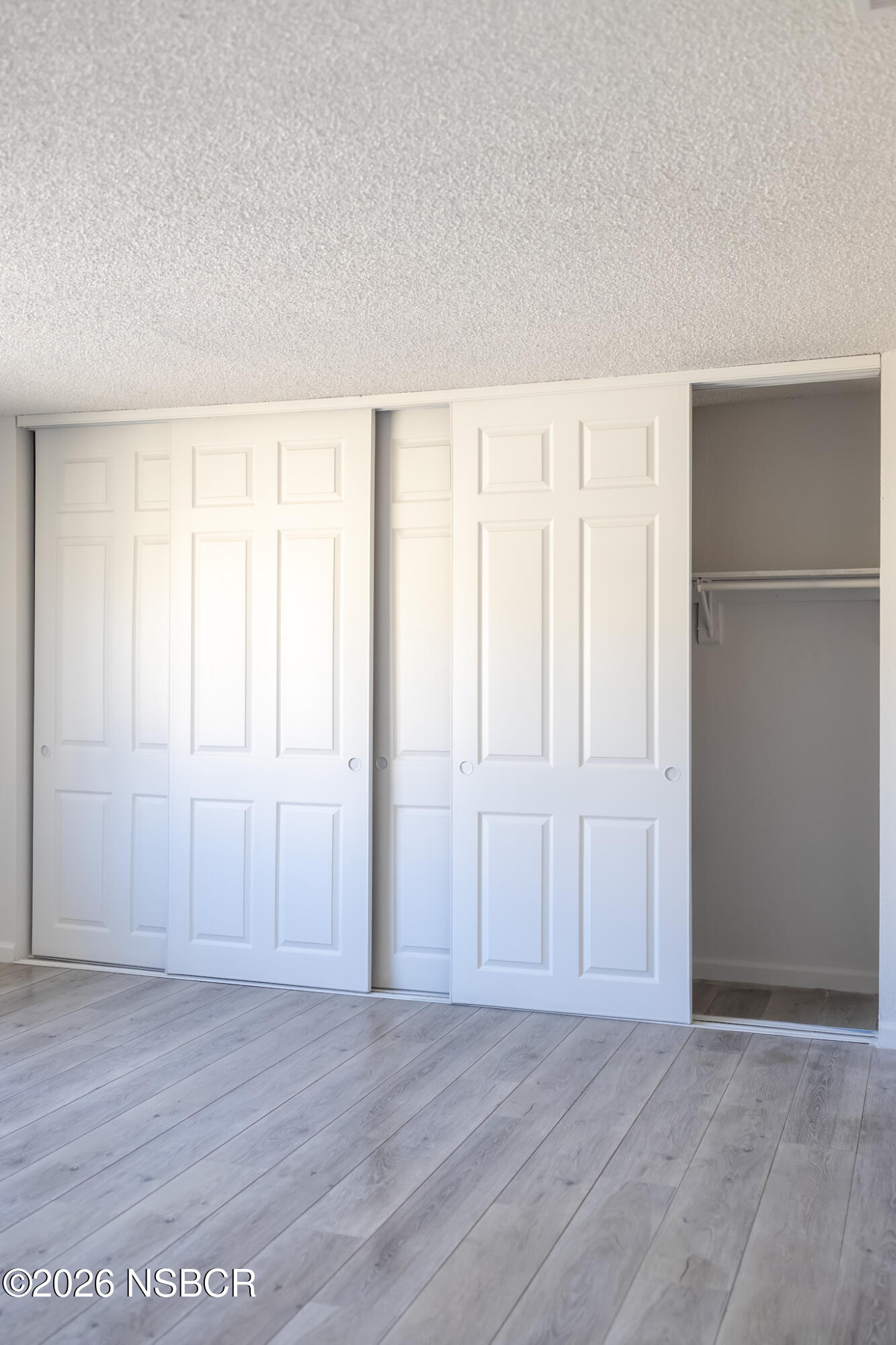 829 Jones Street, Unit 4 Santa Maria, CA 93454 - Photo 13 of 15 an empty room with wooden floor and windows