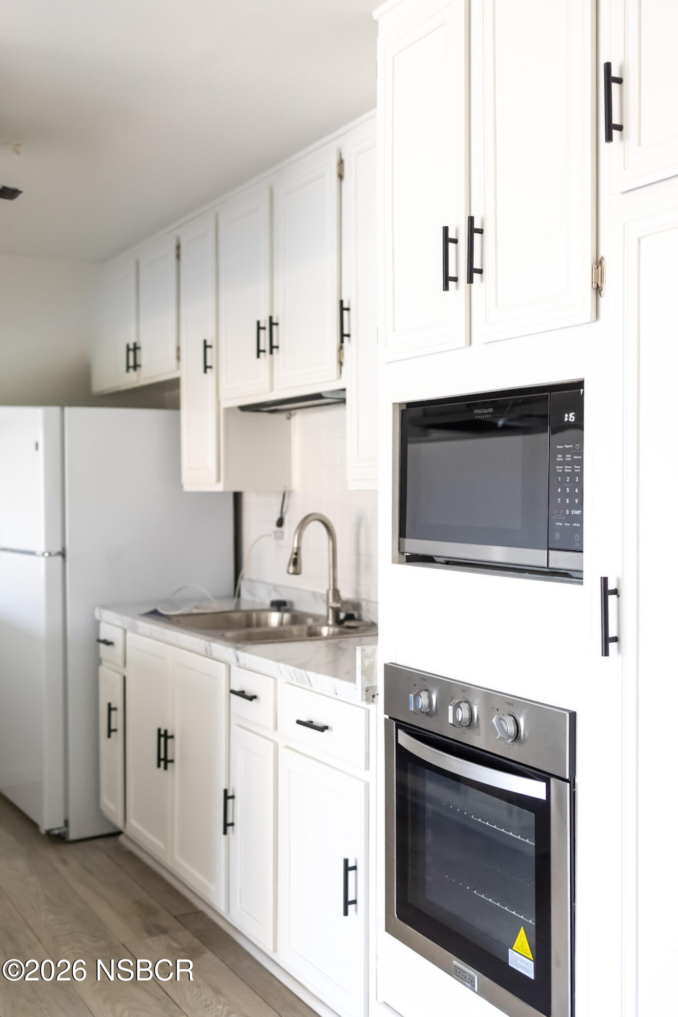 829 Jones Street, Unit 4 Santa Maria, CA 93454 - Photo 2 of 15 a kitchen with stainless steel appliances granite countertop a stove a microwave and a sink