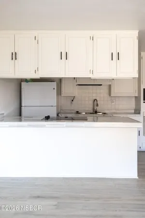 a close view of kitchen countertops with cabinets and wooden floor