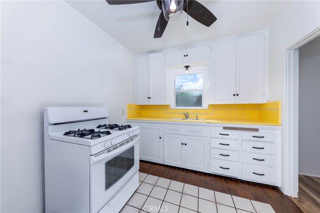 1208 Ohio Street Redlands, CA 92374 - Photo 5 of 14 a kitchen with stainless steel appliances a stove a sink and a microwave