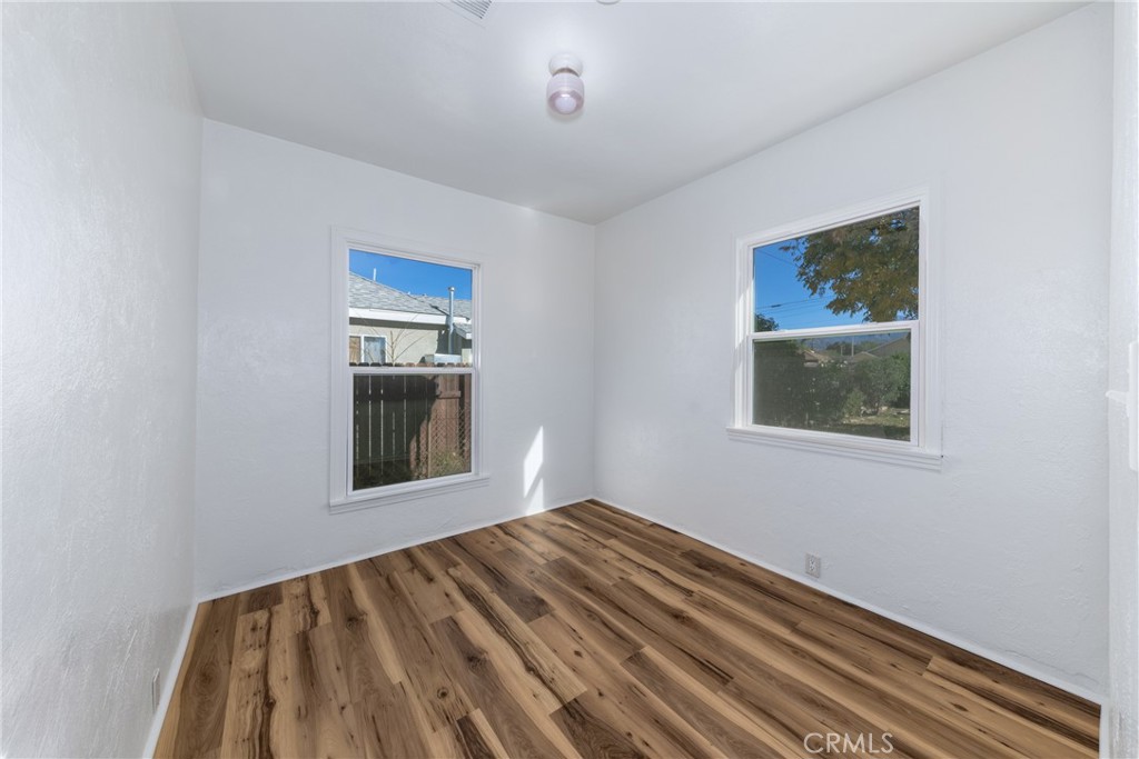1208 Ohio Street Redlands, CA 92374 - Photo 7 of 14 a view of an empty room with wooden floor and a window