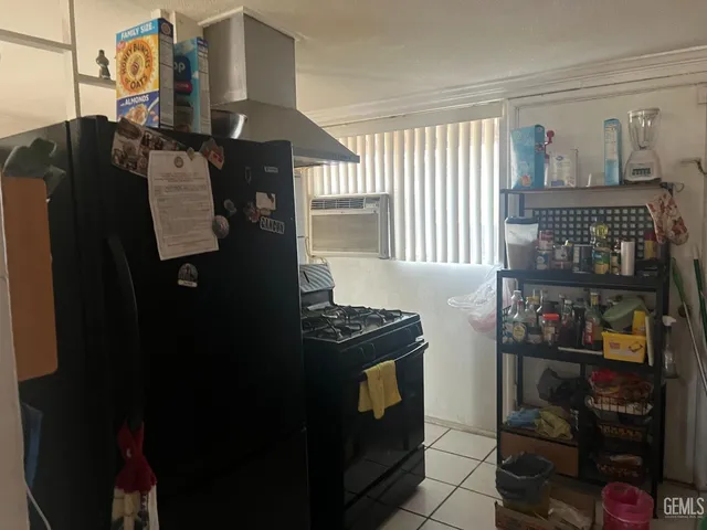 a kitchen with a refrigerator and a stove