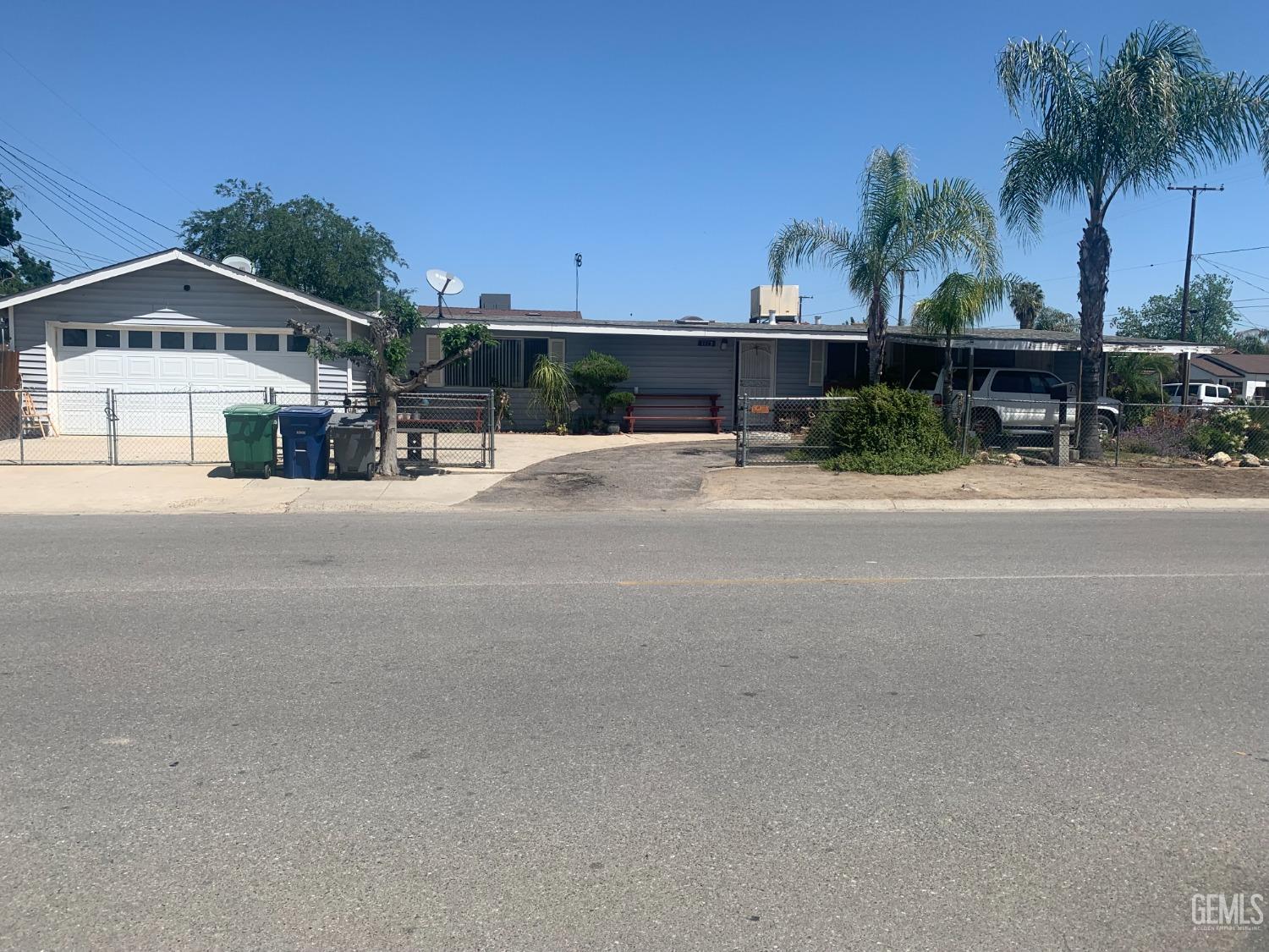 Undisclosed Address Delano, CA 93215 - Photo 2 of 17 a view of a house with a yard and potted plants