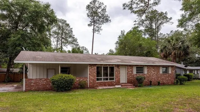 a front view of a house with a garden and porch