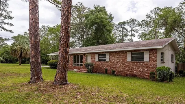 a backyard of a house with yard and outdoor seating