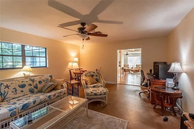 a living room with furniture a window and a flat screen tv