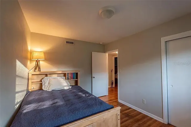 a bedroom with a bed and lamp