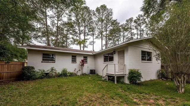 a house that has a tree in front of the house