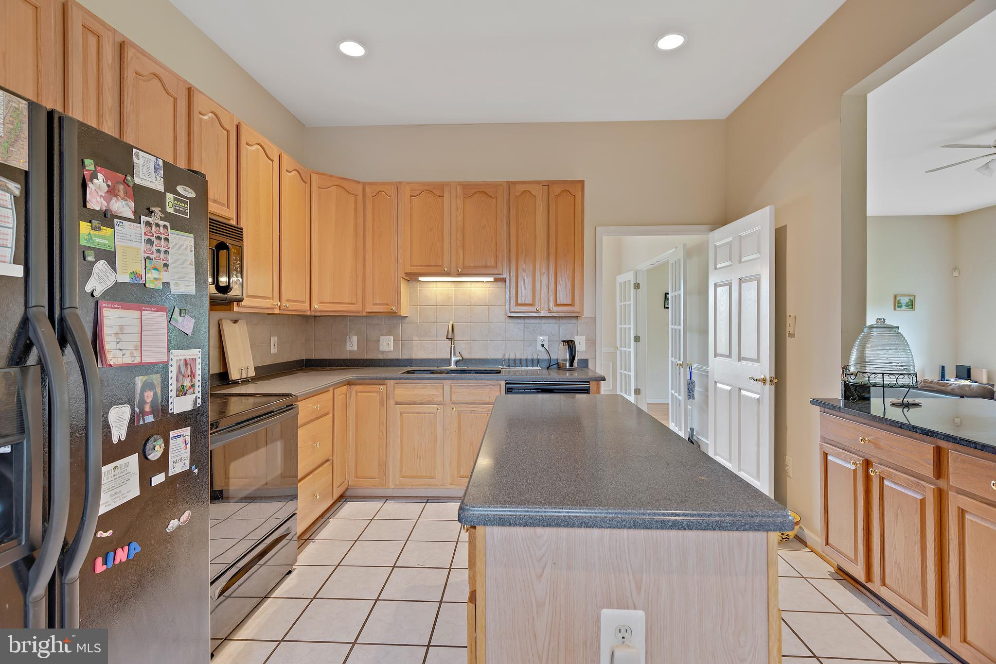 3356 Park Mills Road Frederick, MD 21704 - Photo 16 of 80 a kitchen with stainless steel appliances granite countertop a sink stove and cabinets