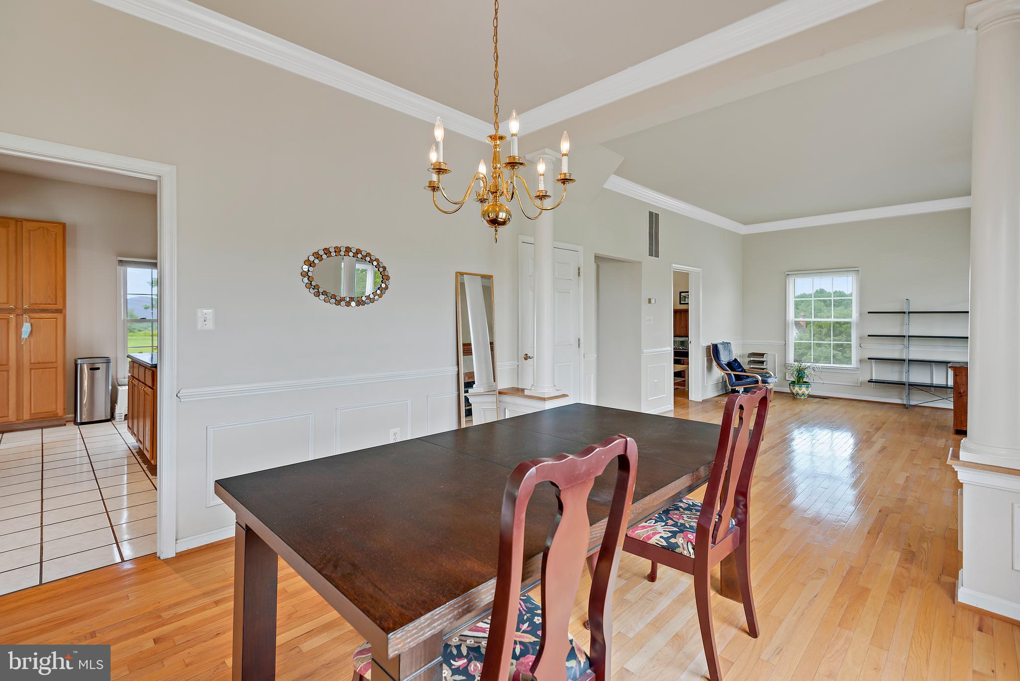 3356 Park Mills Road Frederick, MD 21704 - Photo 22 of 80 a view of a dining room and livingroom with furniture wooden floor a chandelier