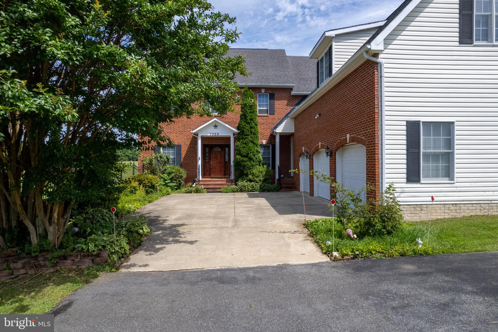 3356 Park Mills Road Frederick, MD 21704 - Photo 4 of 80 a front view of a house with a yard and garage