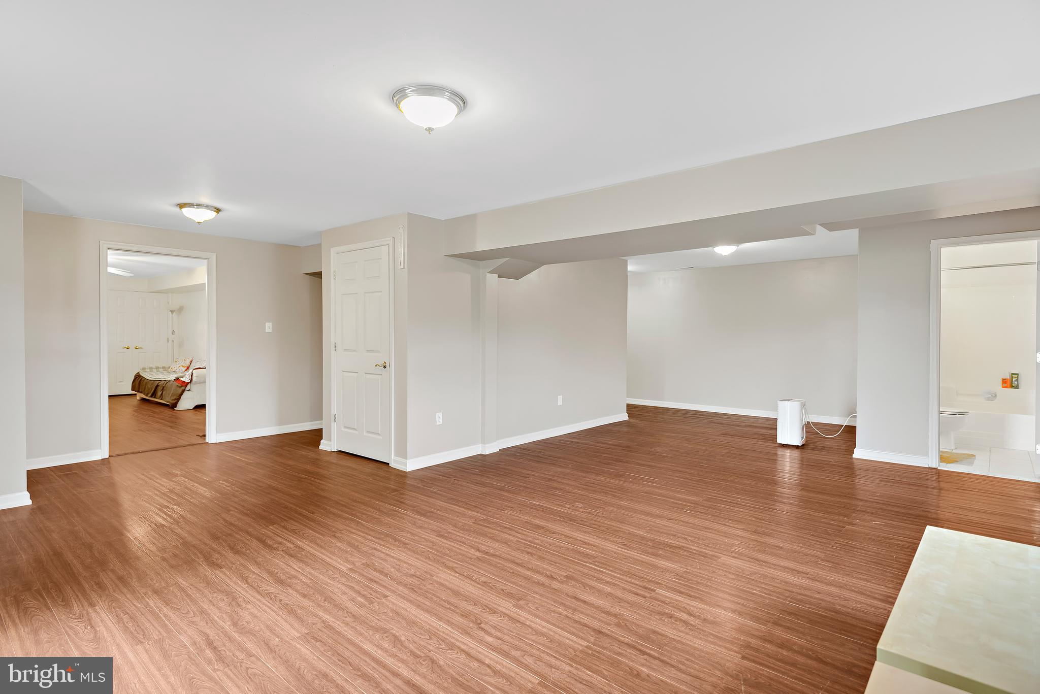 3356 Park Mills Road Frederick, MD 21704 - Photo 64 of 80 a view of an empty room with wooden floor and a bathroom