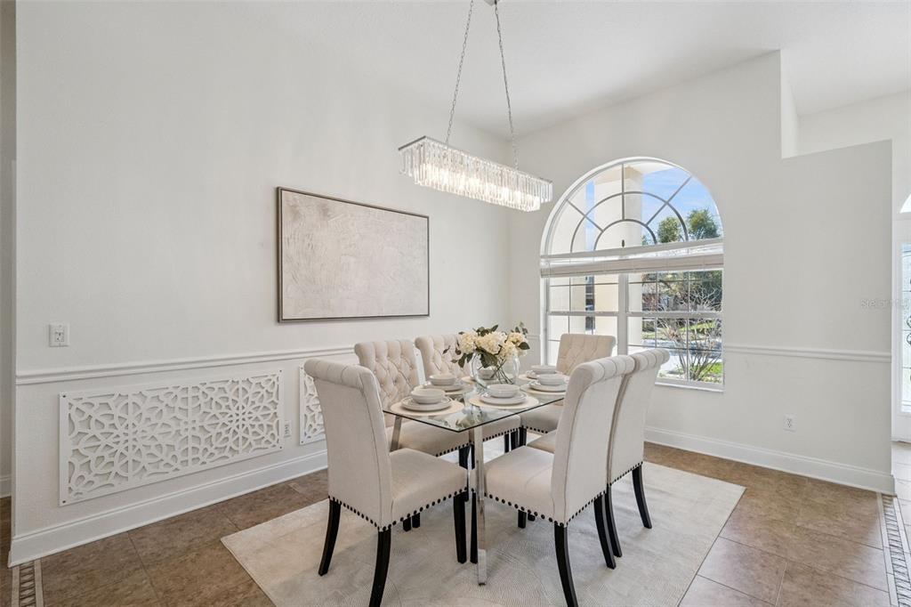 2541 Teton Stone Run Orlando, FL 32828 - Photo 9 of 82 a view of a dining room with furniture a chandelier and wooden floor