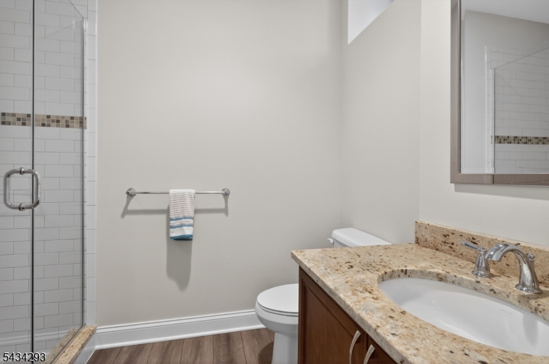 921 Harding Street Westfield, NJ 07090 - Photo 44 of 50 a bathroom with a granite countertop sink toilet and shower