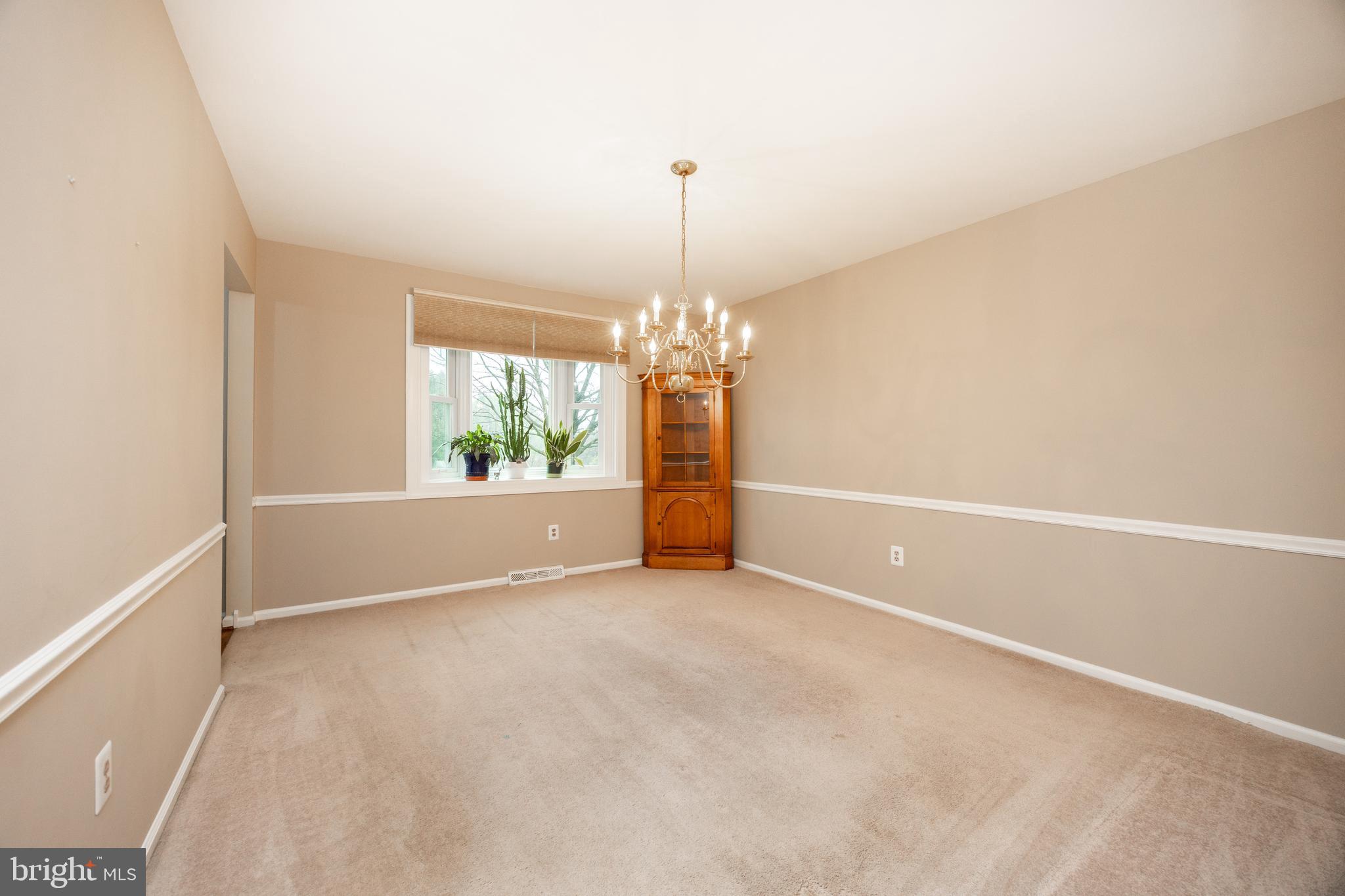 103 Stephen Drive Downingtown, PA 19335 - Photo 5 of 52 an empty room with windows and chandelier