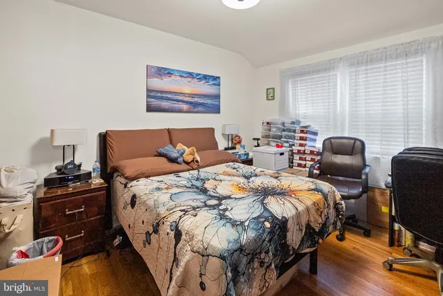 a bedroom with bed chair and window