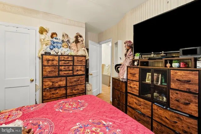 a bedroom with a bed and a television in it