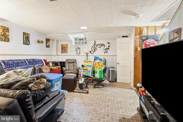 a bedroom with furniture and a flat screen tv