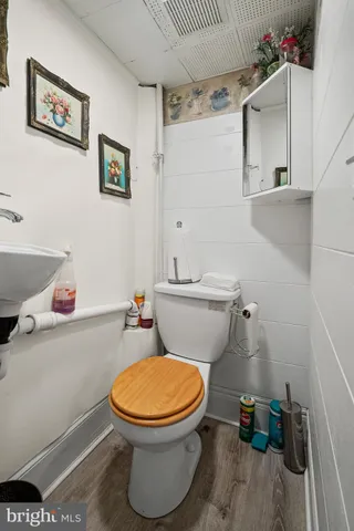 a white toilet sitting next to a bathroom sink and vanity