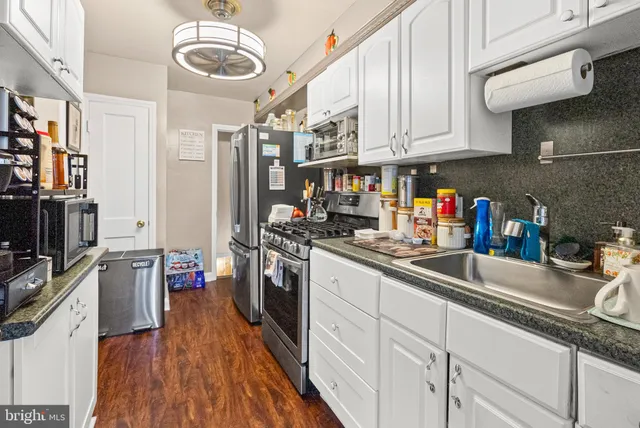 a kitchen with stainless steel appliances granite countertop a sink and cabinets