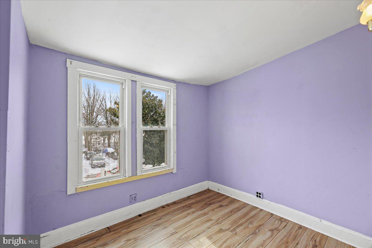 1267 Nottingham Way Hamilton, NJ 08609 - Photo 15 of 24 a view of an empty room with a window and wooden floor