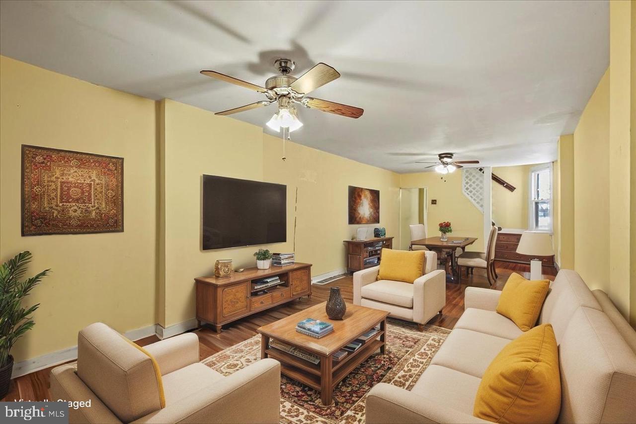 1267 Nottingham Way Hamilton, NJ 08609 - Photo 3 of 24 a living room with furniture a flat screen tv and a window